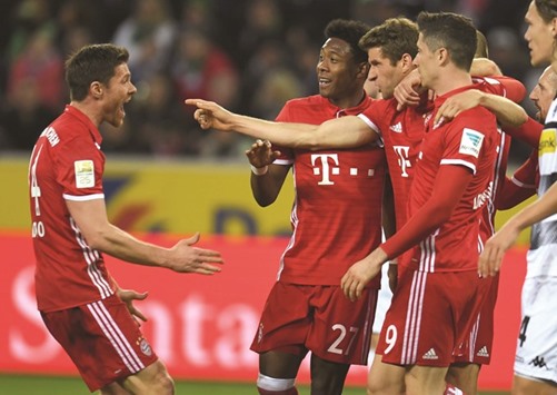 Bayern Munichu2019s Thomas Mueller (centre) celebrates with teammates after scoring a goal during the Bundesliga match against Borussia Moenchengladbach yesterday. (AFP)