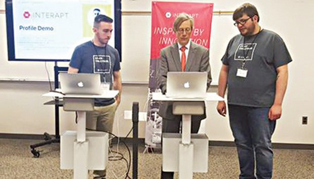 Earl Gohl co-director of the Appalachian Regional Commission in a coding demo with Interapt trainees in Paintsville.