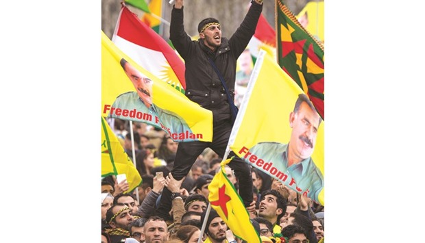 This picture taken on Saturday shows protesters in Frankfurt marking the Kurdish spring festival Newroz and displaying the portrait of PKK leader Abdullah Ocalan.