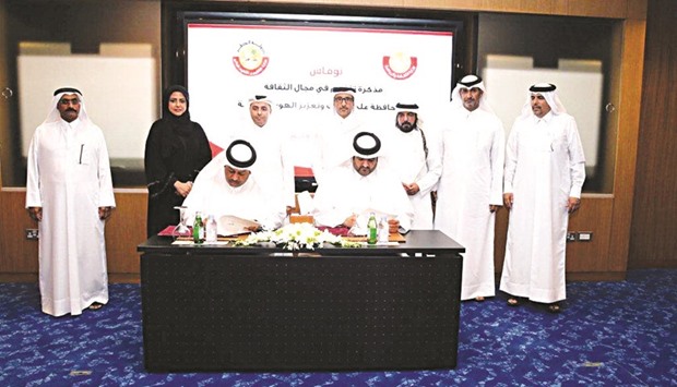 Director of Independent Schools Office Khalifa Saad al-Derham representing the Ministry of Education and Director of Activities, and Youth Events Abdul Rahman bin Mohamed al-Hajri, on behalf of the Ministry of Culture, sign the MoU.