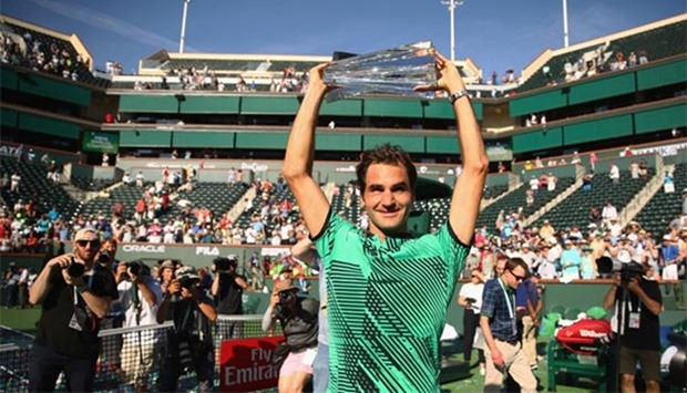 Roger Federer holds the BNP Paribas Open trophy aloft after his straight sets victory against Stan Wawrinka in Indian Wells on Sunday.