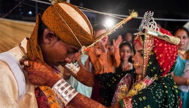 A Pakistani Hindu couple perform a ritual during a mass wedding ceremony in Karachi on Sunday. 