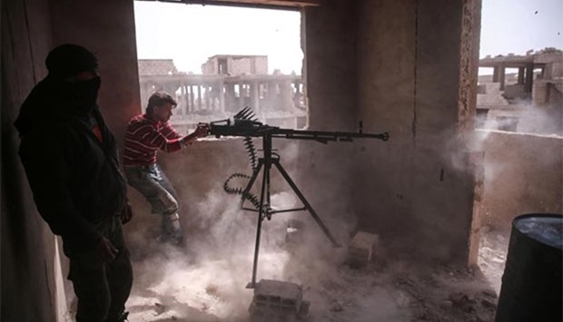An opposition fighter from the Failaq al-Rahman brigade fires a machine gun in Jobar, a rebel-held district in Damascus, on Sunday.