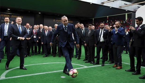 President Recep Tayyip Erdogan kicks a ball at the Halic Congress Centre in Istanbul on Monday.