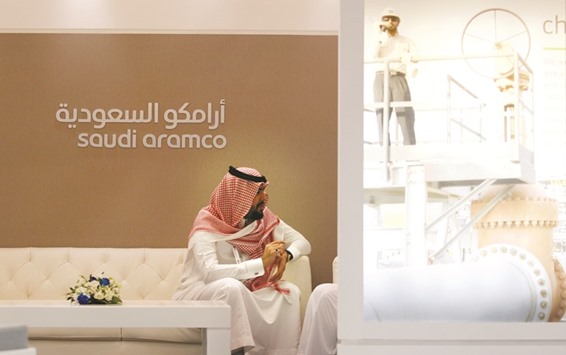 A Saudi Aramco employee sits in the area of its stand at the Middle East Petrotech 2016 in Manama (file). Singapore, along with Hong Kong and Tokyo have been mentioned as possible exchanges where Aramcou2019s shares would be traded after what could be the worldu2019s largest-ever initial public offering.