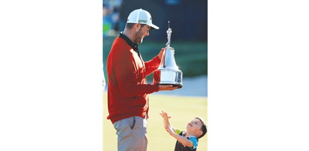 Marc Leishman of Australia celebrates with his son after winning the Arnold Palmer Invitational in Orlando, Florida.
