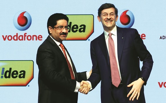 Kumar Mangalam Birla, chairman of Aditya Birla Group (left), shakes hands with Vittorio Colao, CEO of Vodafone Group, after a news conference in Mumbai yesterday.