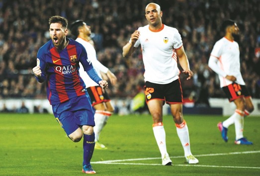 Barcelonau2019s Lionel Messi celebrates after scoring his second goal against Valencia in the La Liga at Camp Nou stadium, Barcelona. (Reuters)