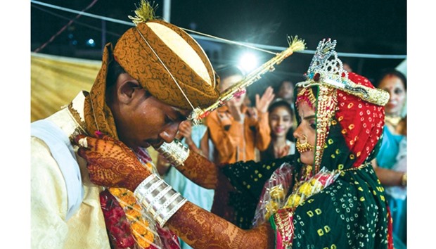 A Pakistani Hindu couple performs a Hindu ritual during a mass wedding ceremony in Karachi, on March 19.