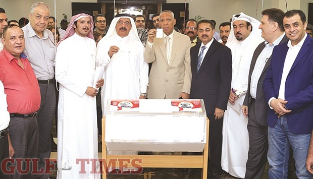 Yousef al-Darwish and Mohammad Allam Ali of Gulf Publishing & Printing Co holding the winning coupons in the draw, alongside Ministry, Company representatives and other officials.