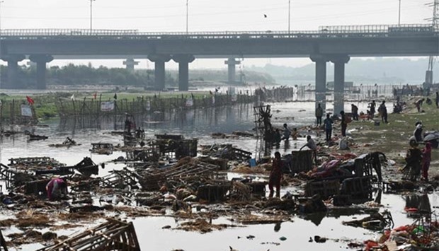 Indian scavengers looking for reusable items piled up in the Yamuna river in New Delhi.