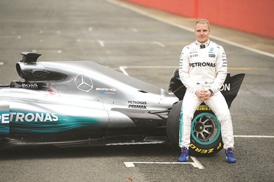 This file photo taken on February 23, 2017 shows Mercedes AMG Petronas Formula One driver Finlandu2019s Valtteri Bottas sitting on the new 2017 season Mercedes W08 EQ Power+ Formula One car at its launch event at Silverstone motor racing circuit near Towcester, central England. (AFP)