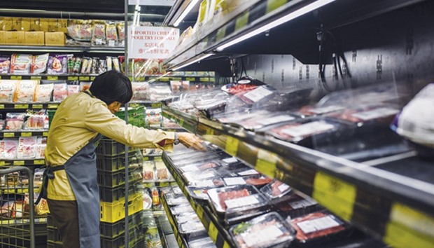 A staff member removes packs of imported meat from Brazil off the shelves of a supermarket in Hong Kong yesterday.