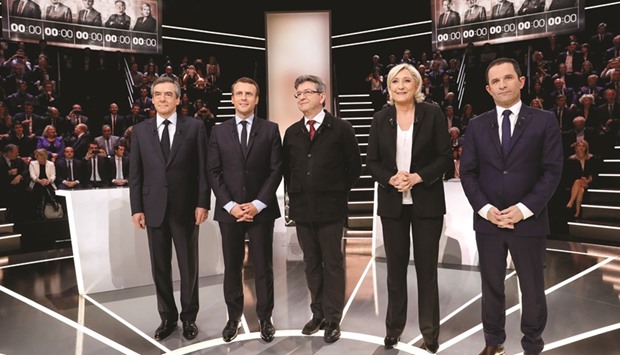 French presidential election candidates (from left) Fillon, Macron, Melenchon, Le Pen, and Hamon, pose before the debate organised by the French private TV channel TF1 on Monday night.