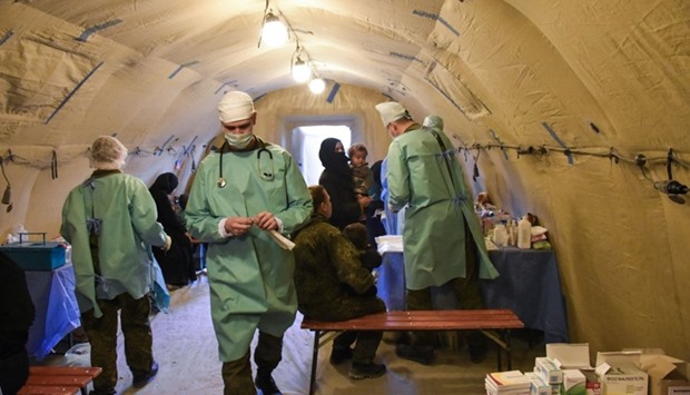 Russian Army doctors distribute medical aid and vaccines through paediatric field hospitals for displaced Syrians in the district of Jibreen, on the outskirts of the northern Syrian city of Aleppo.  AFP