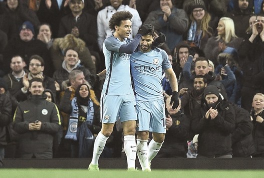 Manchester Cityu2019s Argentinian striker Sergio Aguero (R) celebrates with Leroy Sane on Wednesday.
