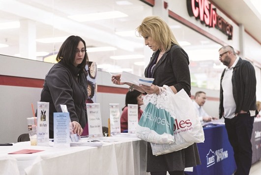 A job seeker (right) speaks with a representative at the Laconia Job & Resource Fair, hosted by the New Hampshire Employment Security, at Belknap Mall in Belmont, New Hampshire. Initial claims for state unemployment benefits dropped 19,000 to a seasonally adjusted 223,000 for the week ended February 25, the lowest level since March 1973, the US Labour Department said yesterday.