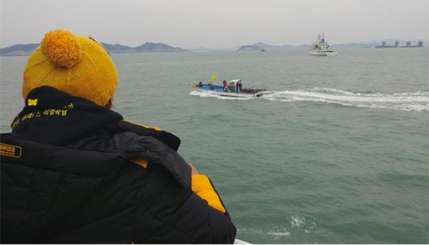 Relatives of victims of the Sewol ferry disaster looking at the Chinese salvaging vessels as they prepare to lift the wreck of the Sewol ferry in the sea off the southwestern island of Jindo on Wednesday.