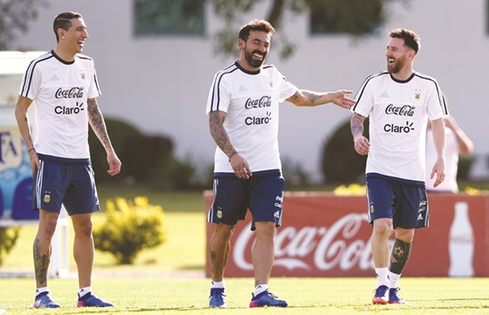 Argentinau2019s superstar Lionel Messi (right) shares a joke with teammates Ezequiel Lavezzi (centre) and Angel Di Maria during a training session ahead of their 2018 World Cup qualifiers against Chile in Buenos Aires, Argentina yesterday. (Reuters)