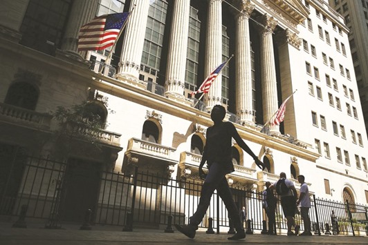 People walk by the New York Stock Exchange. The S&P 500 Index rose in seven of Trumpu2019s first eight weeks in office before suffering on Tuesday its biggest one-day setback under the new administration. Yet the Federal Reserve appears unswayed by the marketu2019s euphoria.