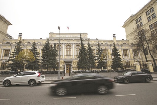 Vehicles pass in front of the headquarters of Russiau2019s central bank in Moscow. The Bank of Russia has said a u201cmoderately tightu201d stance is needed to bring inflation to its 4% target at end-2017.