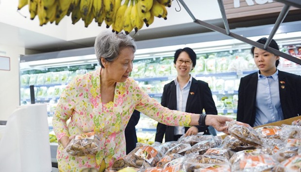 Ho Ching, wife of Singaporeu2019s Prime Minister Lee Hsien Loong, visits a trade centre in Ho Chi Minh city yesterday.