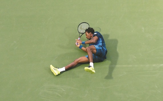 Franceu2019s Gael Monfils falls during his quarter-final with Fernando Verdasco of Spain at the Dubai Duty Free Championships in Dubai yesterday. (AFP)