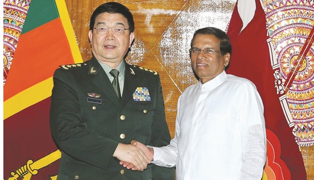 Sri Lankan President Maithripala Sirisena, right, shakes hands with Chinese State Councillor, Defence Minister Chang Wanquan in Colombo.