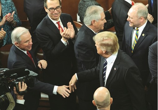 This February 28 file photo shows Sessions reaching out to shake hands with President Trump after Trumpu2019s address to a joint session of Congress at the US Capitol in Washington, DC.