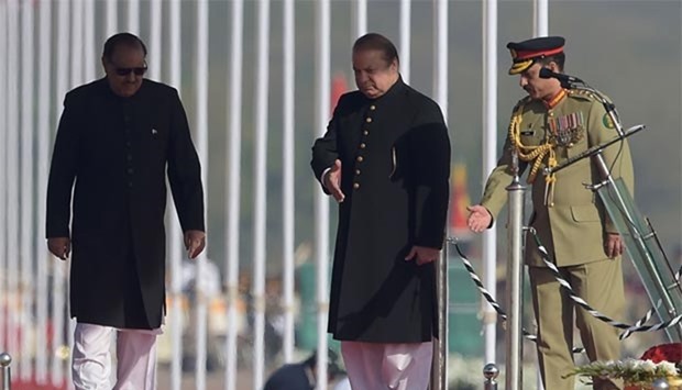 Prime Minister Nawaz Sharif guides President Mamnoon Hussain during a Pakistan Day military parade in Islamabad on Thursday.