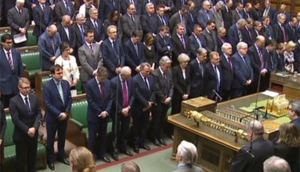 Members of parliament, including British Prime Minister Theresa May, stand for a minute's silence following the terror attack in London.