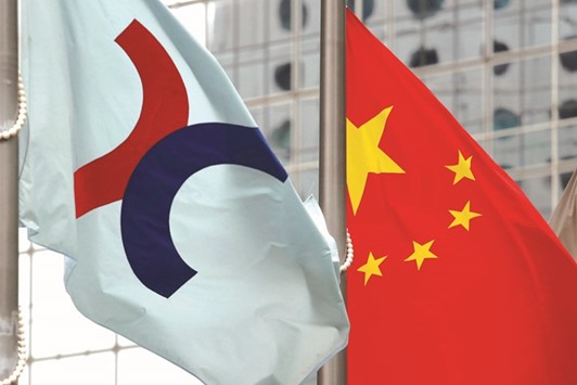 A Hong Kong Exchangeu2019s flag (left) is hoisted beside a Chinese national flag outside the Hong Kong bourse. Prospective cornerstone investors in Hong Kong initial public offerings (IPOs) of mainland firms now have to inform Chinese regulators of their intentions and promise to return funds to the mainland whenever they sell holdings, sources said.