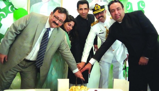 Ambassador Shahzad Ahmad and officers of the Pakistan embassy cutting the cake
