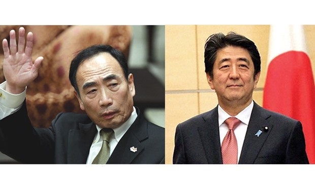 Yasunori Kagoike (Left) and  Shinzo Abe ... raging controversy.