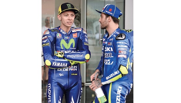 TIPS PLEASE: Seven-time champion Valentino Rossi (left) seems to be intently listening to his compatriot Andrea Iannone.