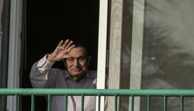 Mubarak waving to people from his room at the Maadi military hospital in Cairo, as his supporters gather to celebrate the 43rd anniversary of October War victory.  October 6, 2016 file picture.