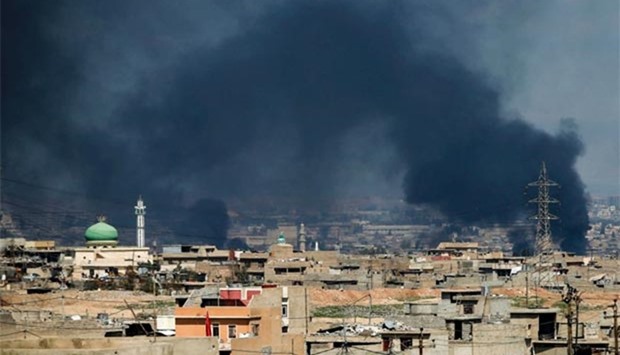 Smoke plumes rising in a neighbourhood in west Mosul on Friday.