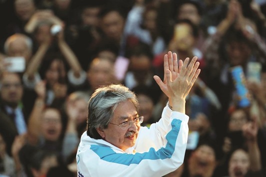 Candidate John Tsang, former financial secretary, attends an election campaign at the financial Central district, two days before the Chief Executive election, in Hong Kong.