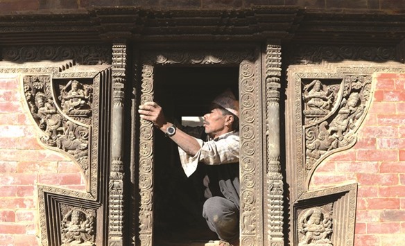 A worker renovates a heritage site at Durbar Square in Kathmandu.