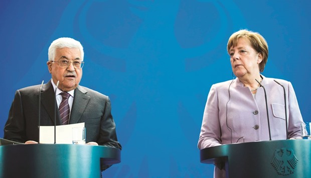 German Chancellor Angela Merkel and Palestinian President Mahmoud Abbas, attend a press conference ahead of talks on the Israeli-Palestinian conflict at the chancellery in Berlin yesterday.