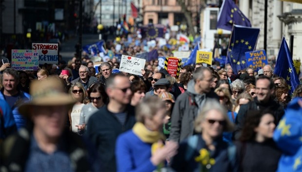 Demonstrators hold placards and wave EU flags during an anti Brexit, march in London