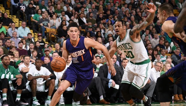 Devin Booker (left) scored an NBA season-high 70 points, the most points scored in a game against the Boston Celtics, but it wasnu2019t enough for Phoenix Suns on Friday night.