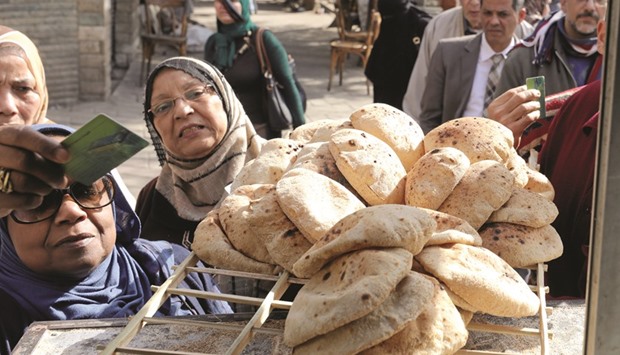 People buy bread at a bakery in Cairo on March 9. After the pound lost half its value, inflation surged to 30%. There are about 92mn Egyptians. Hardly any of them care about the price of stocks. Almost all of them care about the price of food.