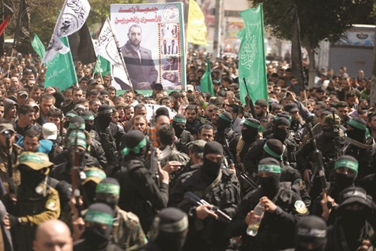 Palestinian members of Hamasu2019 armed wing take part in the funeral of  militant Mazen Faqha in Gaza City yesterday.