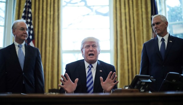President Trump reacts to the AHCA health care bill being pulled by Congressional Republicans before a vote as he appears with Secretary of Health and Human Services Tom Price (L) and Vice President Mike Pence (R) in the Oval Office of the White House in Washington.