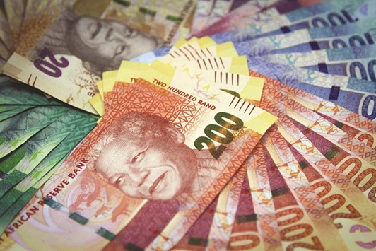 Mixed denomination rand currency banknotes are arranged for a photograph at a First National Bank branch in Johannesburg. The rally that made rand the worldu2019s best-performing currency this year might be nearing its end, according to Old Mutual Investment Group.