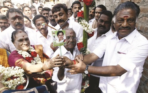 Former Tamil Nadu chief minister O Panneerselvam and the candidate of his All India Anna Dravida Munnetram faction (AIADMK Puratchithalaivi Amma) for the R K Nagar by-election E Madhusudhanan speak to supporters during the inauguration of the factionu2019s office in Chennai yesterday.