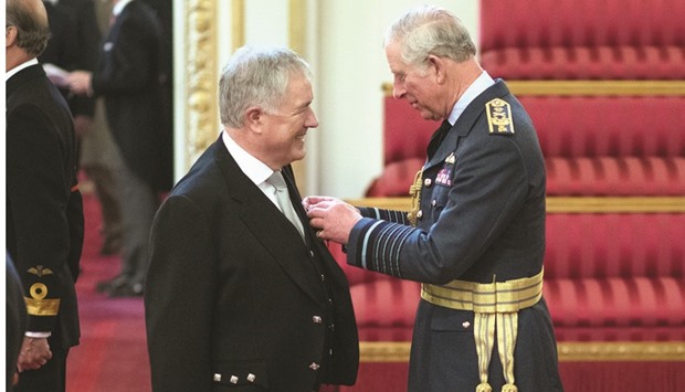 Vodafone Qatar CEO Ian Gray receiving his OBE from Prince Charles.