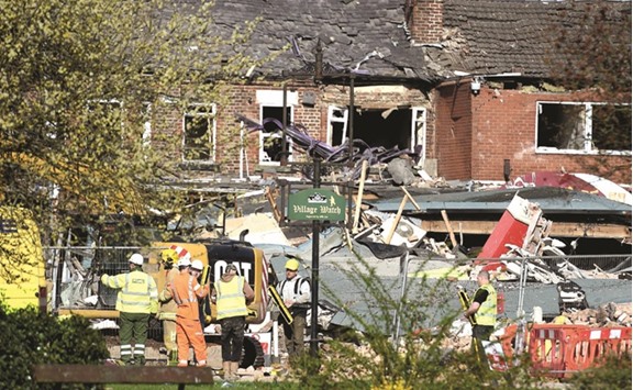 Emergency services work at the scene of a suspected gas explosion in Bebington, Wirral, yesterday.