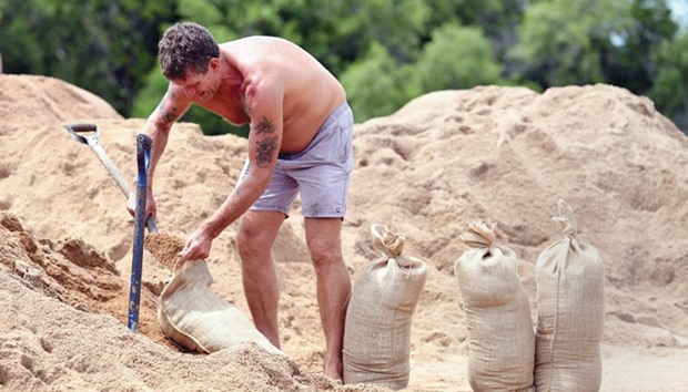 Local resident Barry Simmonds fills up sandbags in preparation for Cyclone Debbie in the Australian city of Townsville, northeastern Queensland.